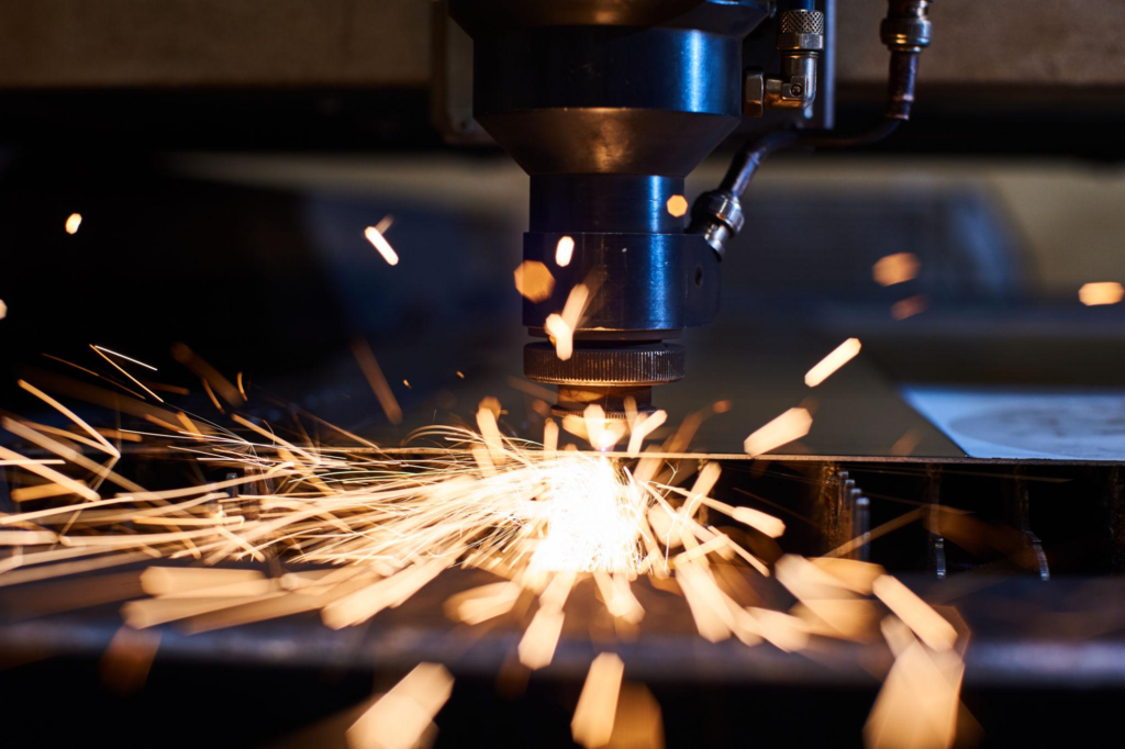 CNC Laser cutting of metal close up, modern industrial technology. Small depth of field